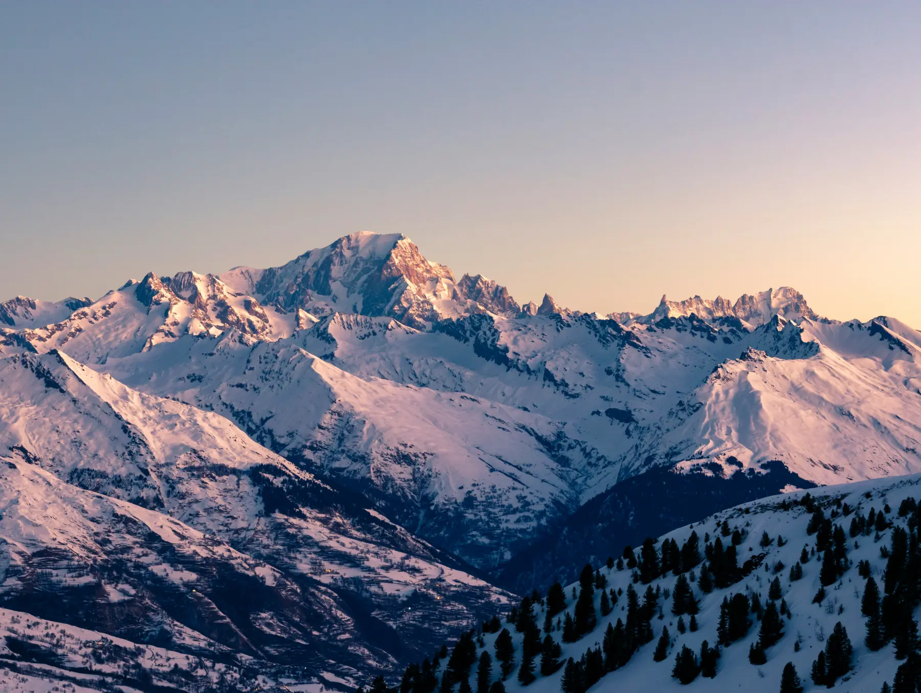 Snow capped mountain range at daybreak